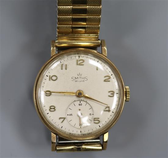 A gentlemans 9ct gold Smiths De Luxe manual wind wrist watch.